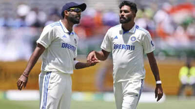 Bumrah and Siraj strategizing on the field.