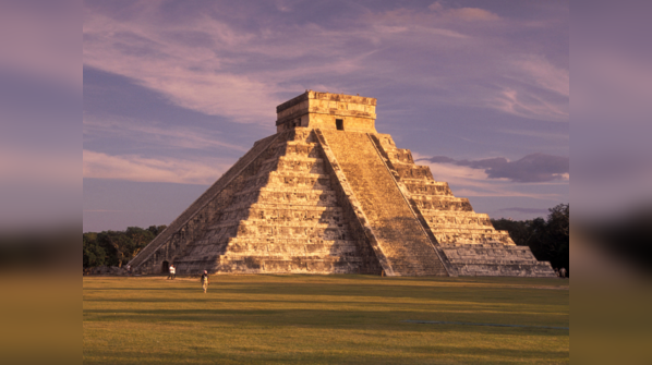 Chichen Itza's pyramid rising above the jungle canopy