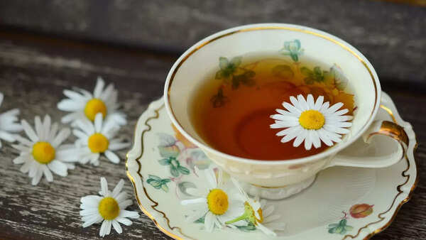 Fragrant chamomile flowers steeping in hot water